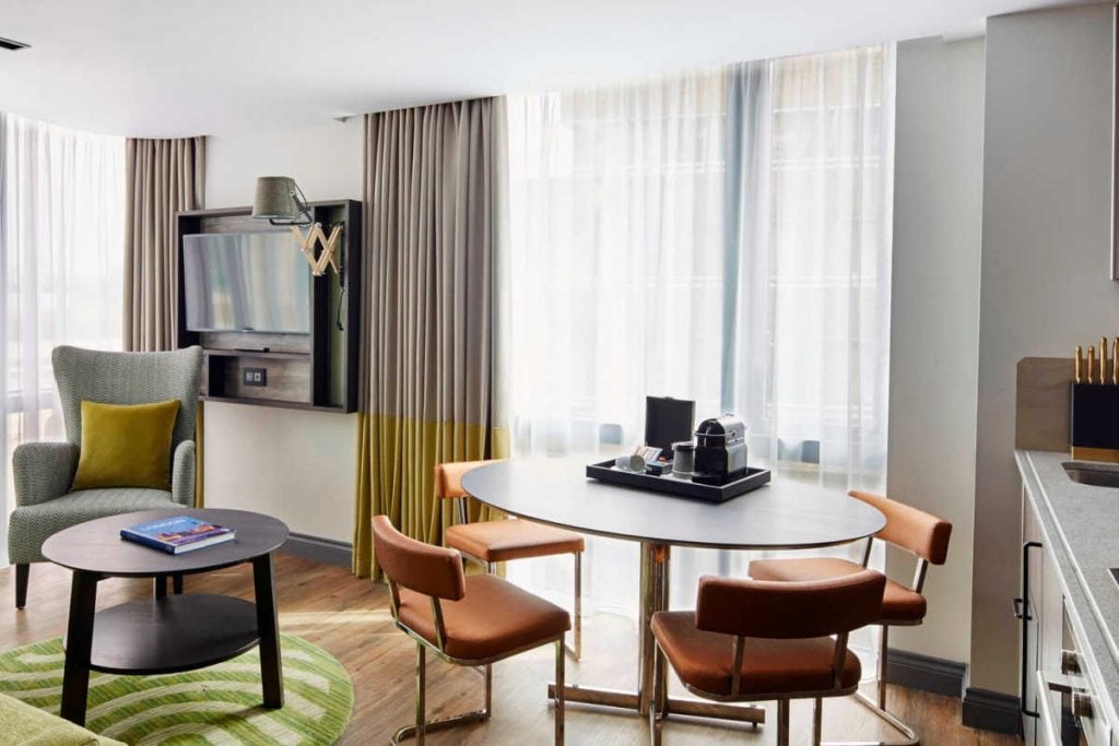 Living and dining area of Kensington Residence Inn suite.